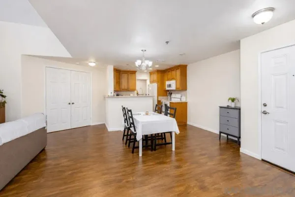 a view of a dining room with furniture and wooden floor
