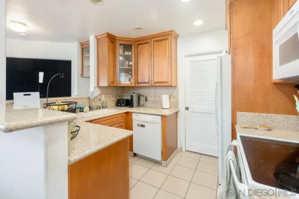a view of a kitchen with a sink a microwave and cabinets