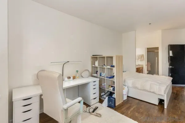 a bedroom with a bed and a chair