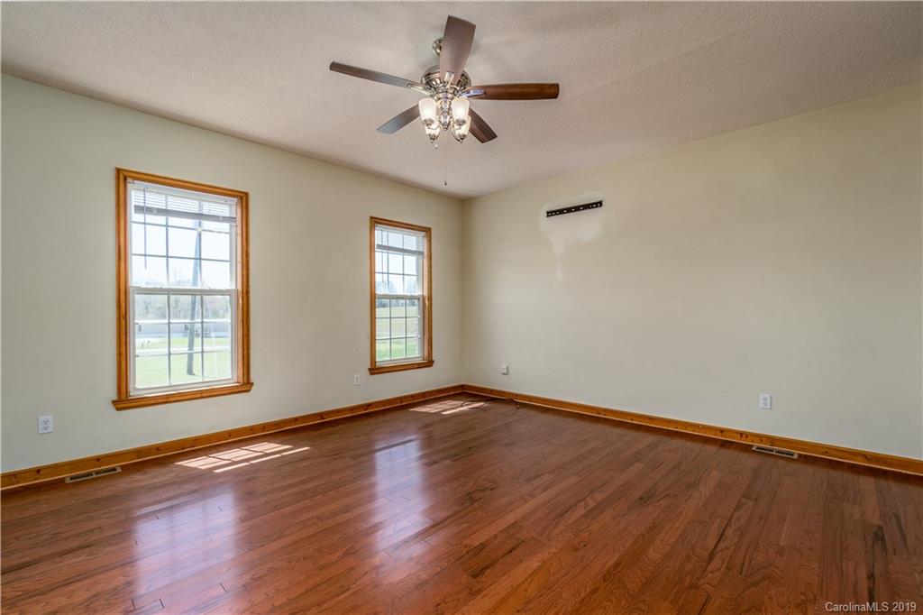 4501 Rowell Road Lancaster, SC 29720 - Photo 17 of 39 a view of an empty room with a window and wooden floor