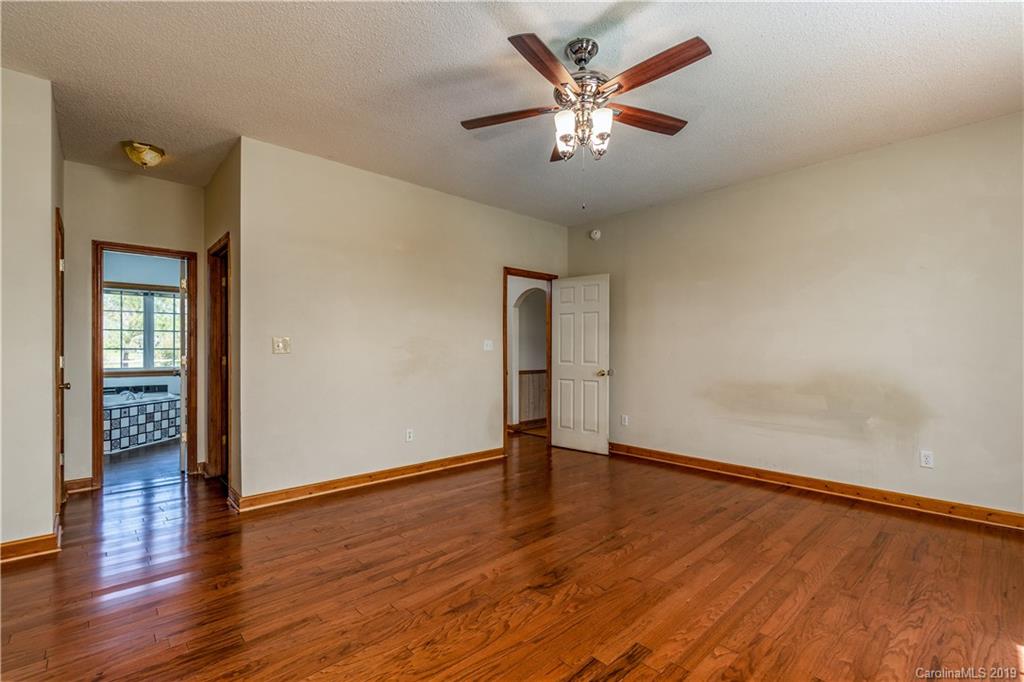 4501 Rowell Road Lancaster, SC 29720 - Photo 18 of 39 an empty room with wooden floor and a ceiling fan