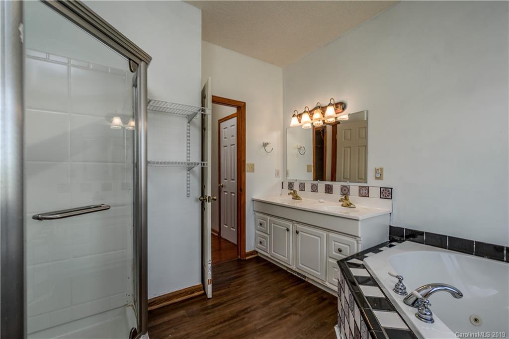 4501 Rowell Road Lancaster, SC 29720 - Photo 20 of 39 a bathroom with a tub sink and mirror