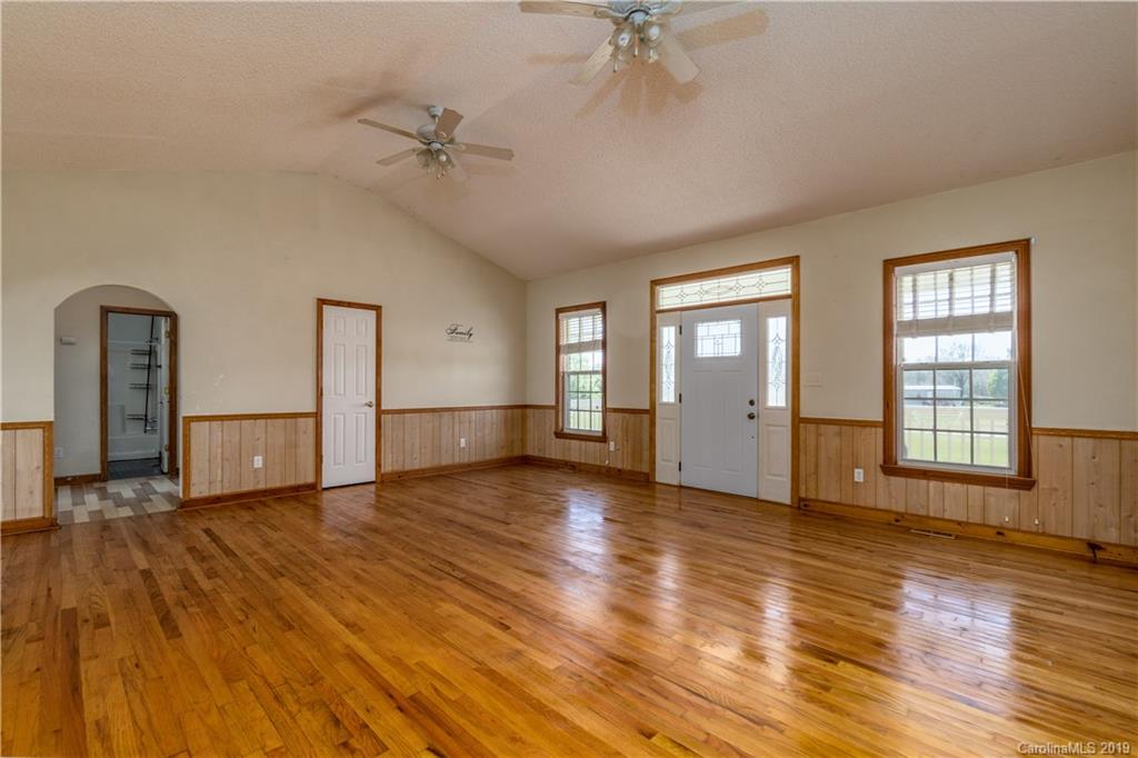 4501 Rowell Road Lancaster, SC 29720 - Photo 22 of 39 a view of an empty room with a window and wooden floor