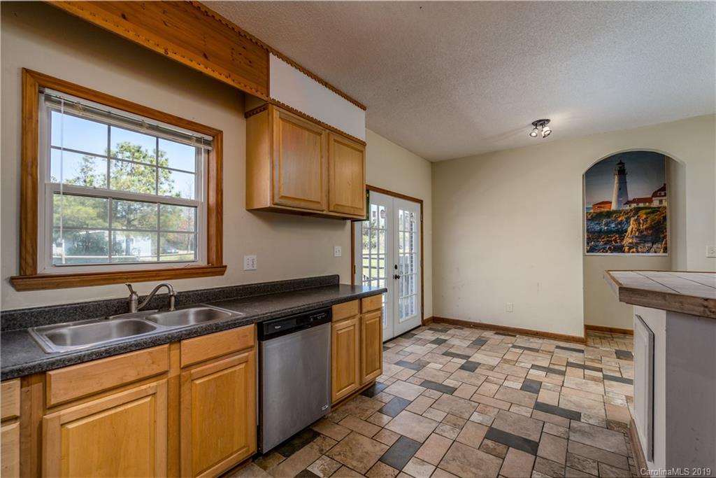 4501 Rowell Road Lancaster, SC 29720 - Photo 7 of 39 a kitchen with granite countertop a sink stove and cabinets