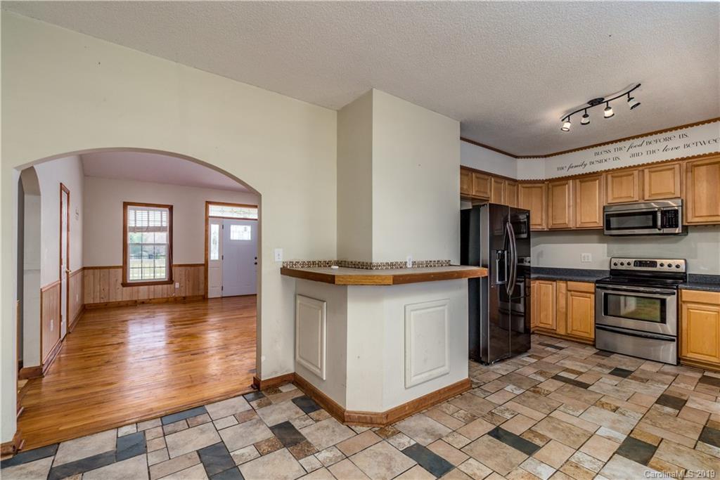 4501 Rowell Road Lancaster, SC 29720 - Photo 9 of 39 a kitchen with stainless steel appliances granite countertop a refrigerator a stove and a sink with granite countertops