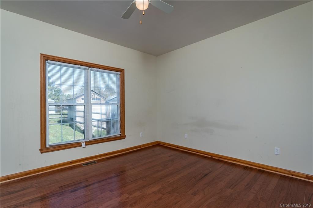 4501 Rowell Road Lancaster, SC 29720 - Photo 10 of 39 an empty room with wooden floor and windows