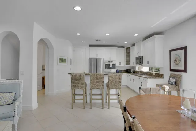a living room with furniture and a dining table