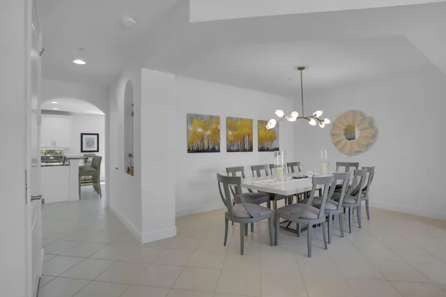 a spacious bedroom with a large bed and a chandelier