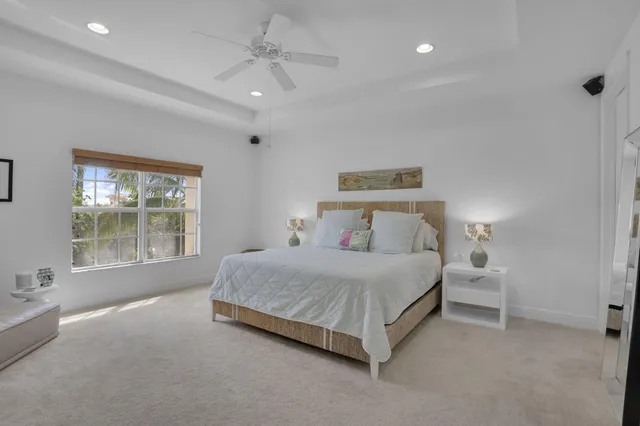 a bedroom with bed and a chandelier
