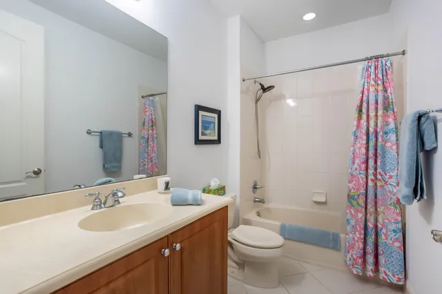 a view of a patio with couple of chairs and a potted plant