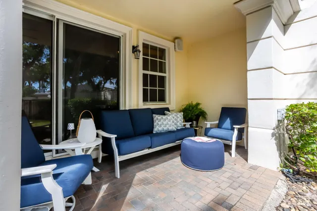 a view of a patio with table and chairs and potted plants with wooden floor