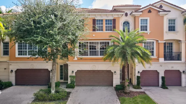 a front view of a house with a potted plant and garage