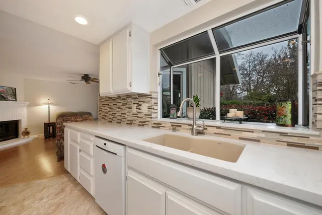 a kitchen with a sink and large window