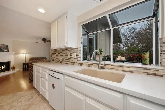 a kitchen with a sink and large window