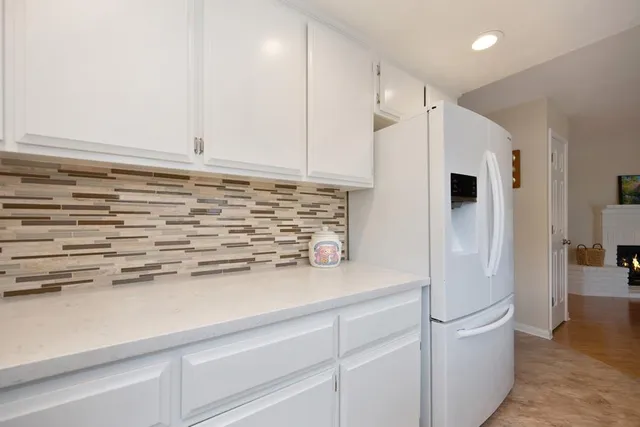 a kitchen with stainless steel appliances a refrigerator and cabinets