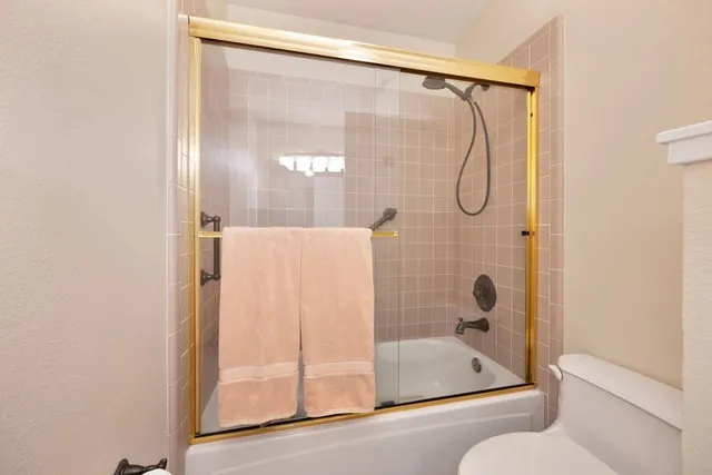 a bathroom with a glass shower door