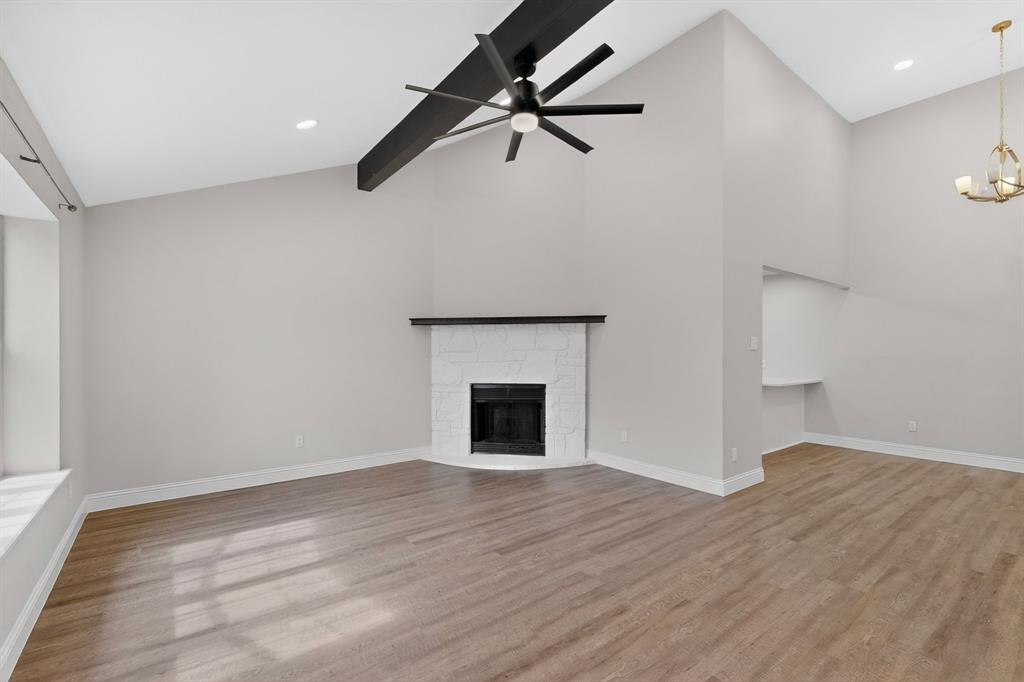 7729 Misty Ridge Drive North Fort Worth, TX 76137 - Photo 4 of 30 a view of empty room with wooden floor and fireplace