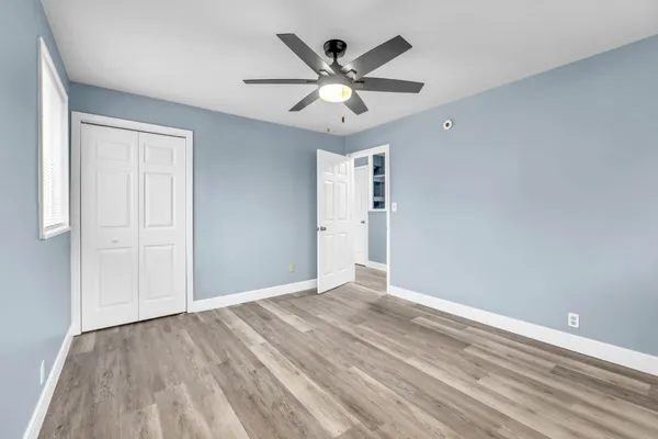 wooden floor in a room with a ceiling fan