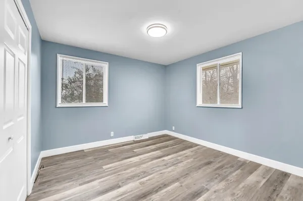 a view of a room with wooden floor and window