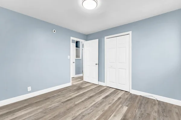 a view of an empty room and wooden floor