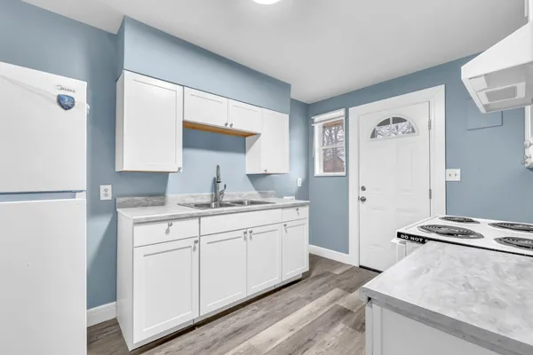 a kitchen with stainless steel appliances granite countertop a sink stove and refrigerator