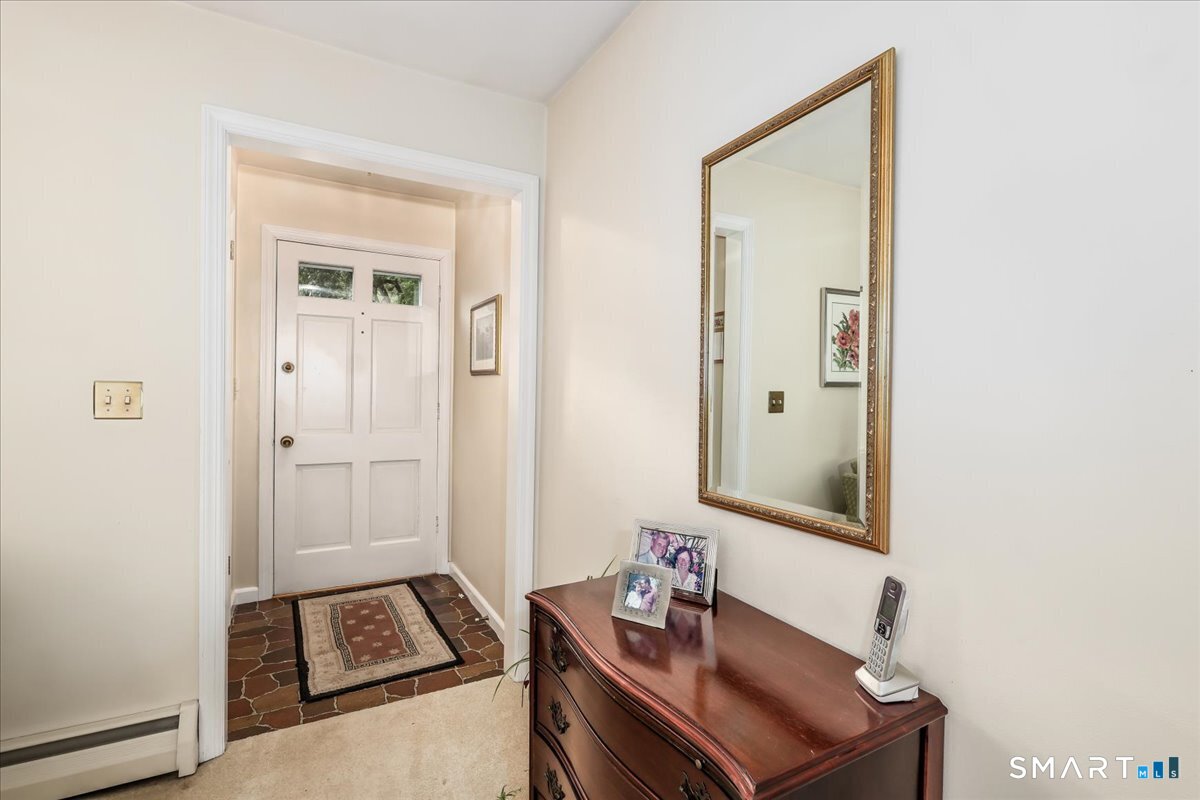 75 Centerbrook Road Fairfield, CT 06824 - Photo 5 of 39 Entry hall with coat closet. Hardwood under vinyl there.