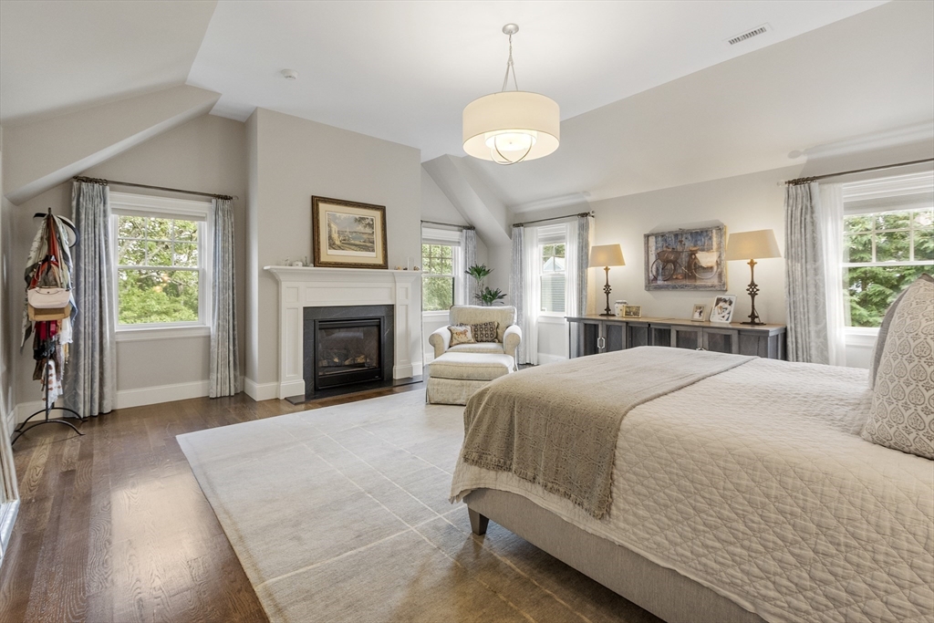 343 Nashawtuc Road Concord, MA 01742 - Photo 20 of 41 a spacious bedroom with a large bed and a fireplace