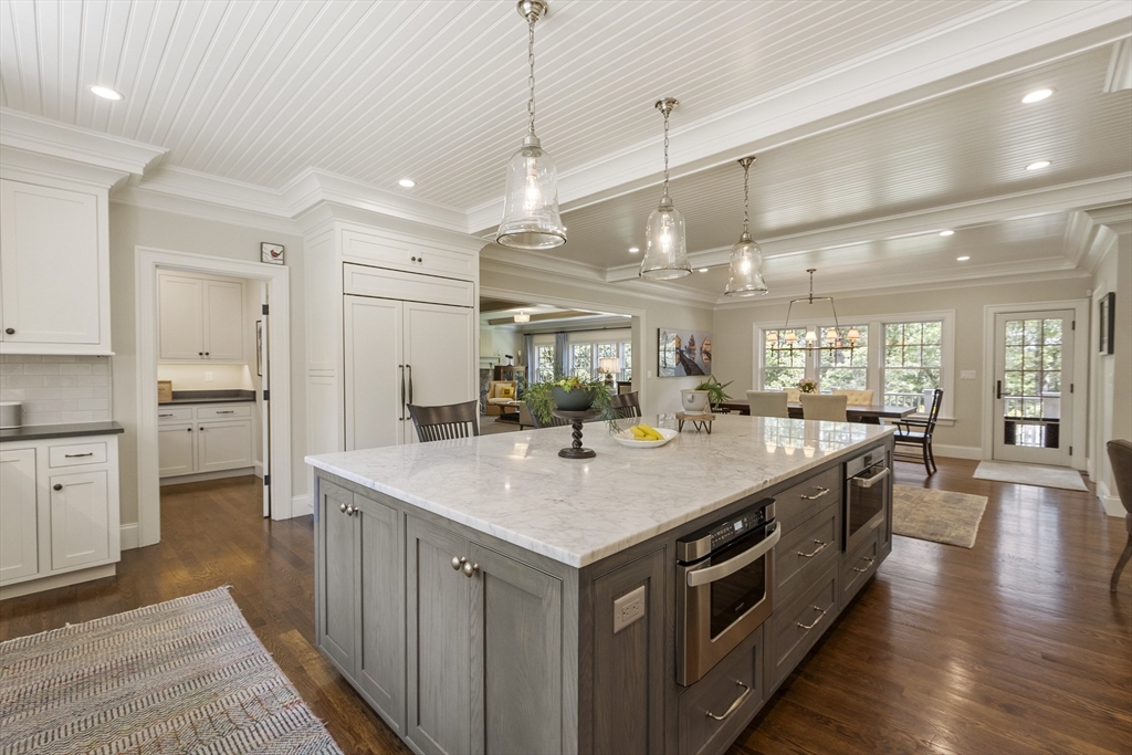 343 Nashawtuc Road Concord, MA 01742 - Photo 2 of 41 a kitchen with a stove center island with wooden floor
