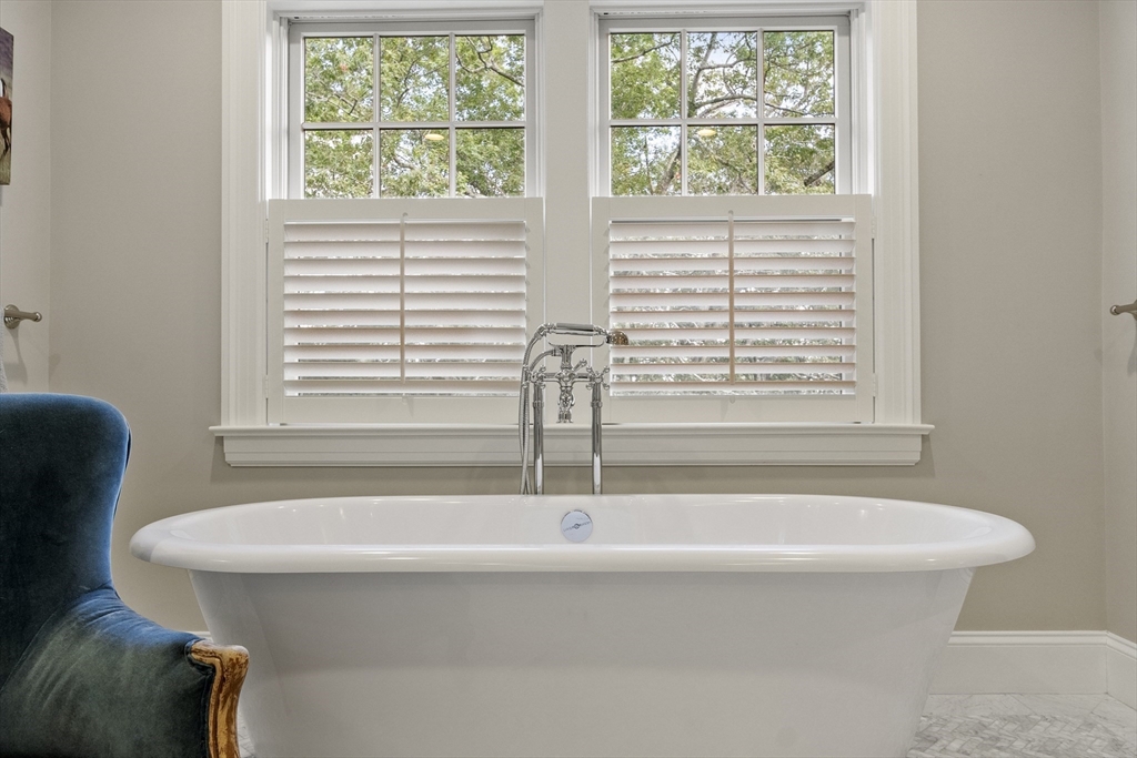 343 Nashawtuc Road Concord, MA 01742 - Photo 23 of 41 a bathroom with a bathtub and next to a window