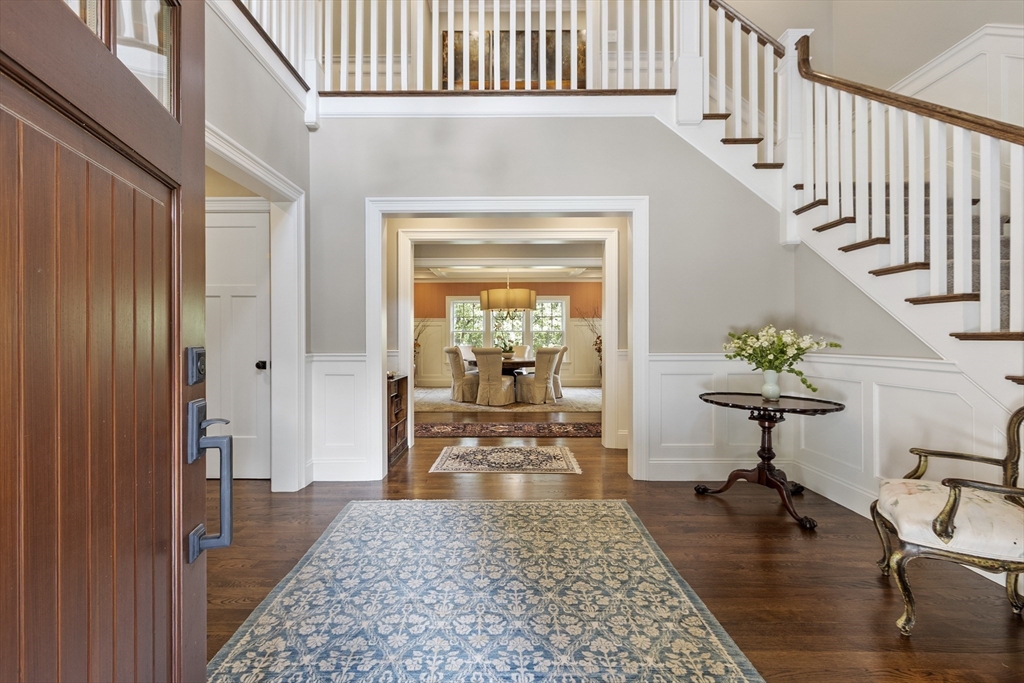 343 Nashawtuc Road Concord, MA 01742 - Photo 3 of 41 a view of a hallway view with wooden floor and a dining table