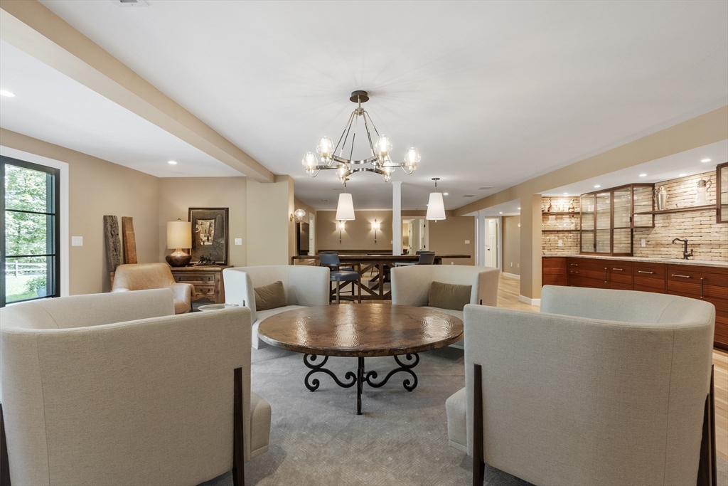 343 Nashawtuc Road Concord, MA 01742 - Photo 31 of 41 a living room with furniture a table and a chandelier
