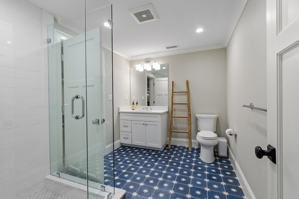 343 Nashawtuc Road Concord, MA 01742 - Photo 34 of 41 a bathroom with a sink a toilet a shower and a mirror