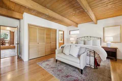 a bedroom with a large bed and a couch