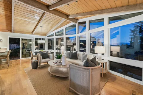 a living room with furniture and a view of balcony