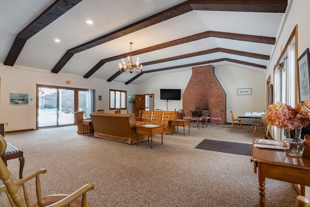 42 Old Colony Way, Unit 29 Orleans, MA 02653 - Photo 13 of 18 a living room with furniture and a chandelier