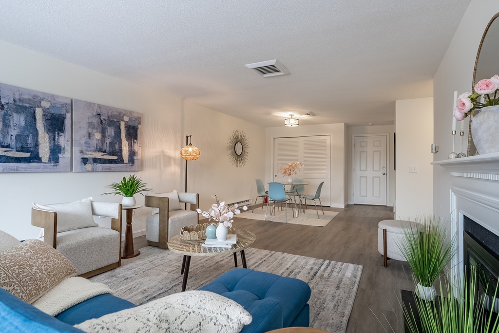 42 Old Colony Way, Unit 29 Orleans, MA 02653 - Photo 2 of 18 a living room with furniture and a fireplace