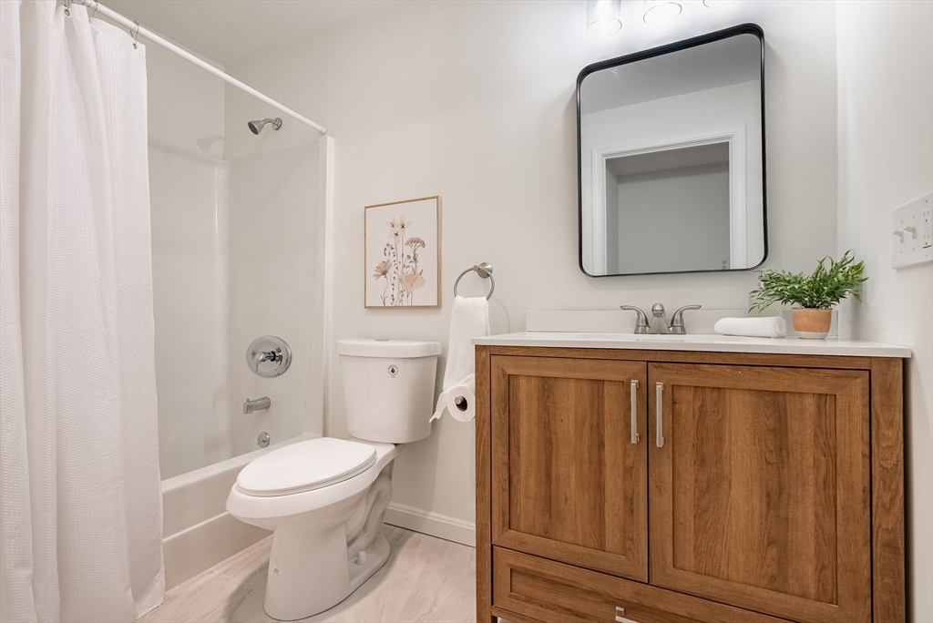 42 Old Colony Way, Unit 29 Orleans, MA 02653 - Photo 4 of 18 a bathroom with a toilet a sink a vanity and mirror
