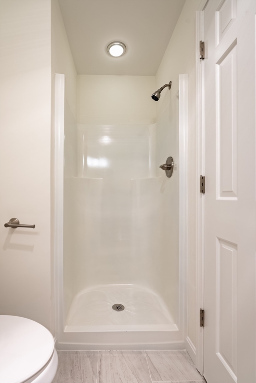 42 Old Colony Way, Unit 29 Orleans, MA 02653 - Photo 8 of 18 a white bath tub sitting next to a toilet