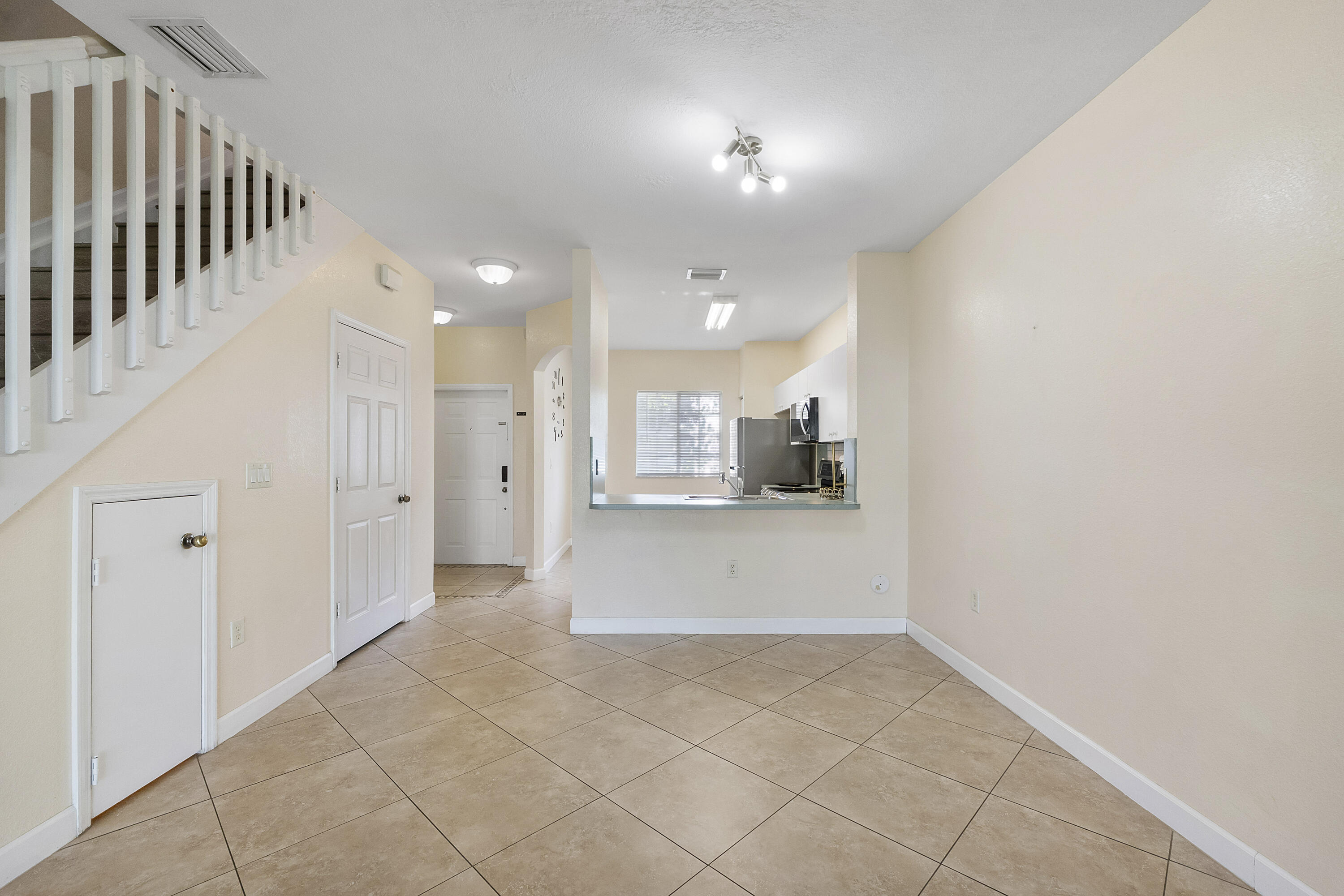 5910 Riverside Avenue Tamarac, FL 33321 - Photo 13 of 47 a view of a hallway with a kitchen