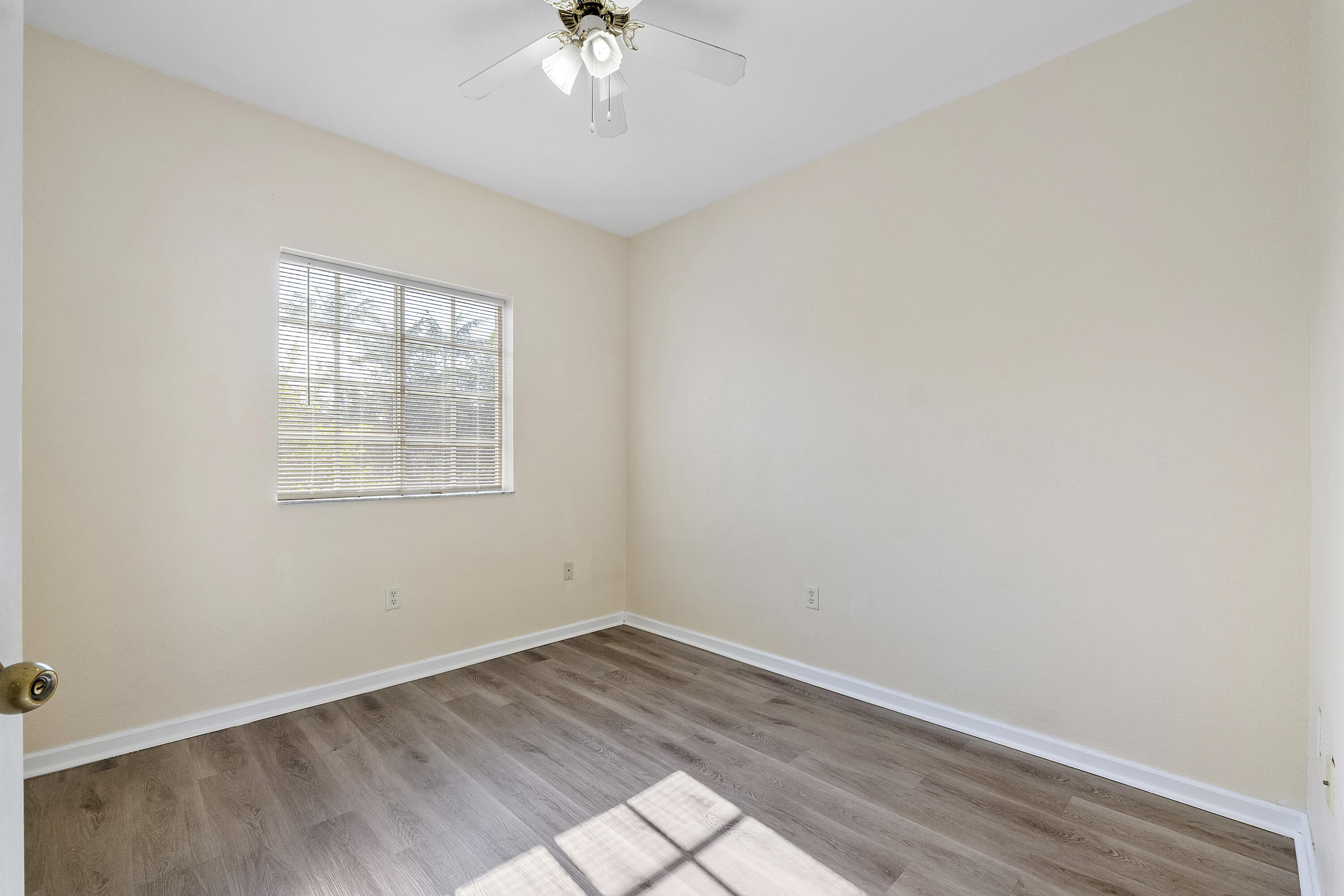5910 Riverside Avenue Tamarac, FL 33321 - Photo 20 of 47 wooden floor in an empty room with a window