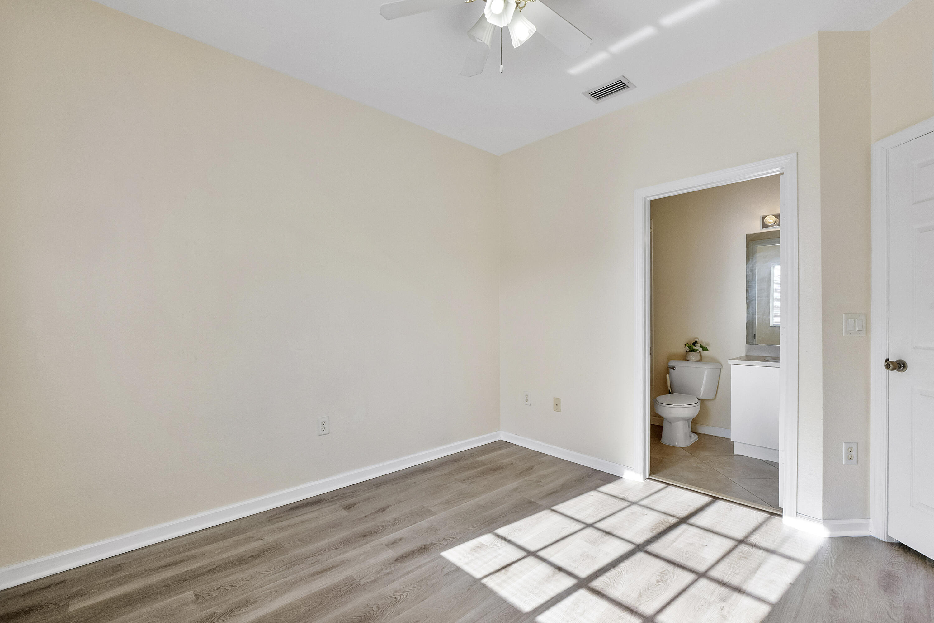 5910 Riverside Avenue Tamarac, FL 33321 - Photo 21 of 47 wooden floor in an empty room and a bathroom