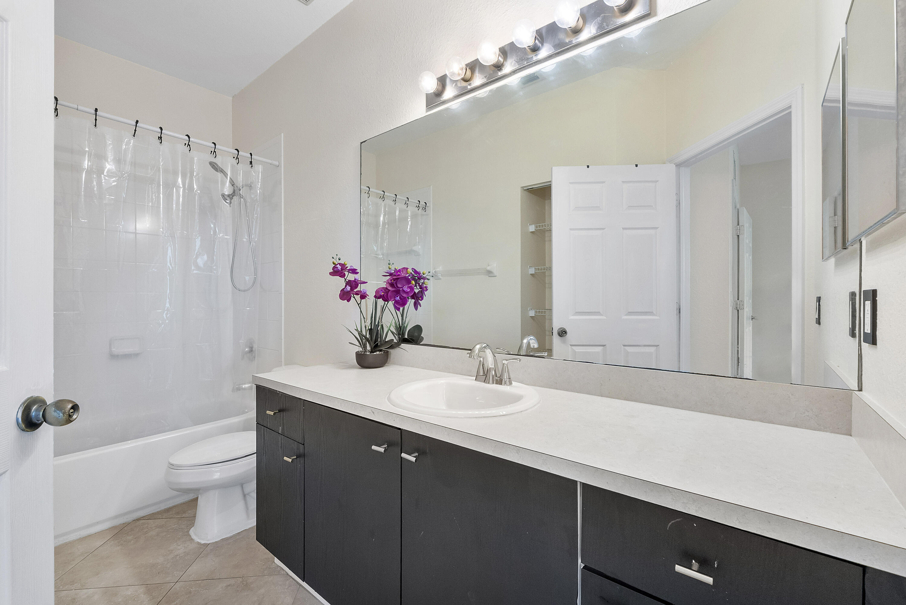5910 Riverside Avenue Tamarac, FL 33321 - Photo 22 of 47 a bathroom with a sink vanity granite and a toilet
