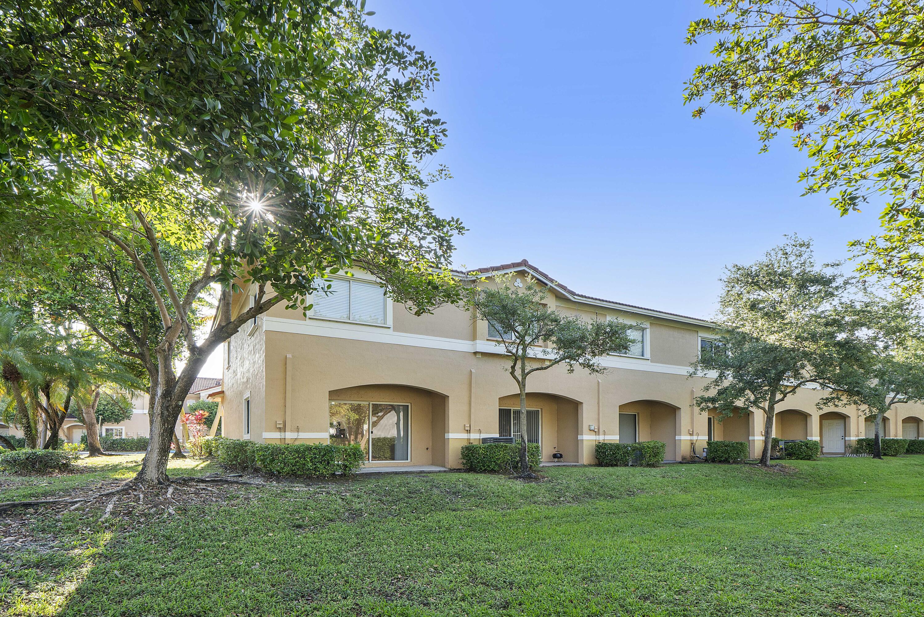 5910 Riverside Avenue Tamarac, FL 33321 - Photo 33 of 47 a front view of a house with a garden