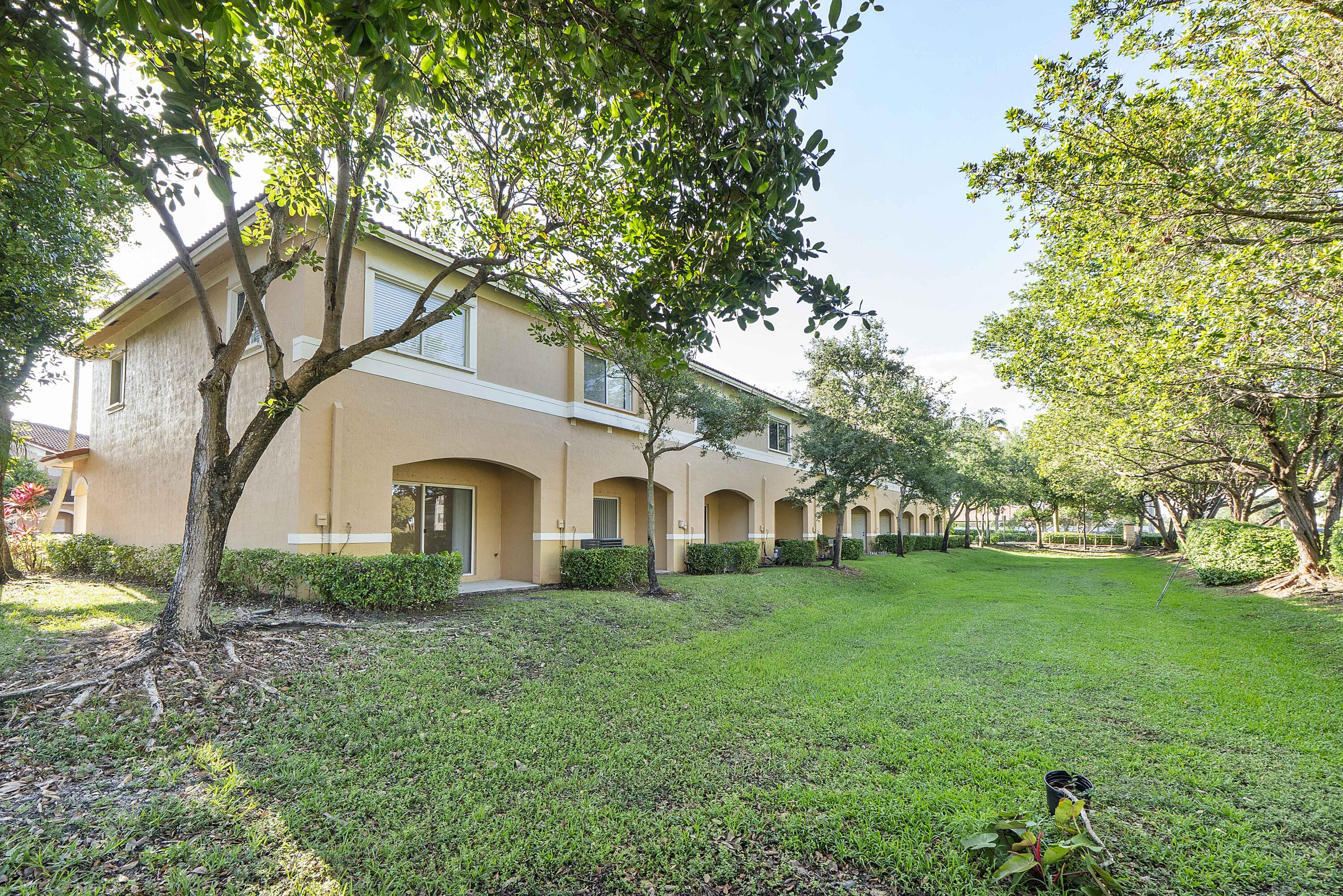 5910 Riverside Avenue Tamarac, FL 33321 - Photo 34 of 47 a front view of a house with garden