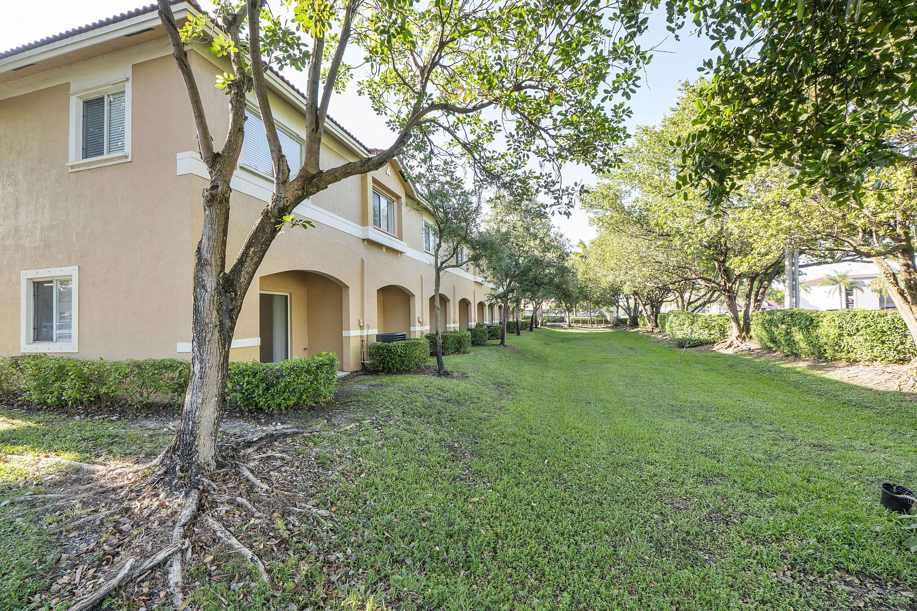 5910 Riverside Avenue Tamarac, FL 33321 - Photo 35 of 47 a view of white house with a yard