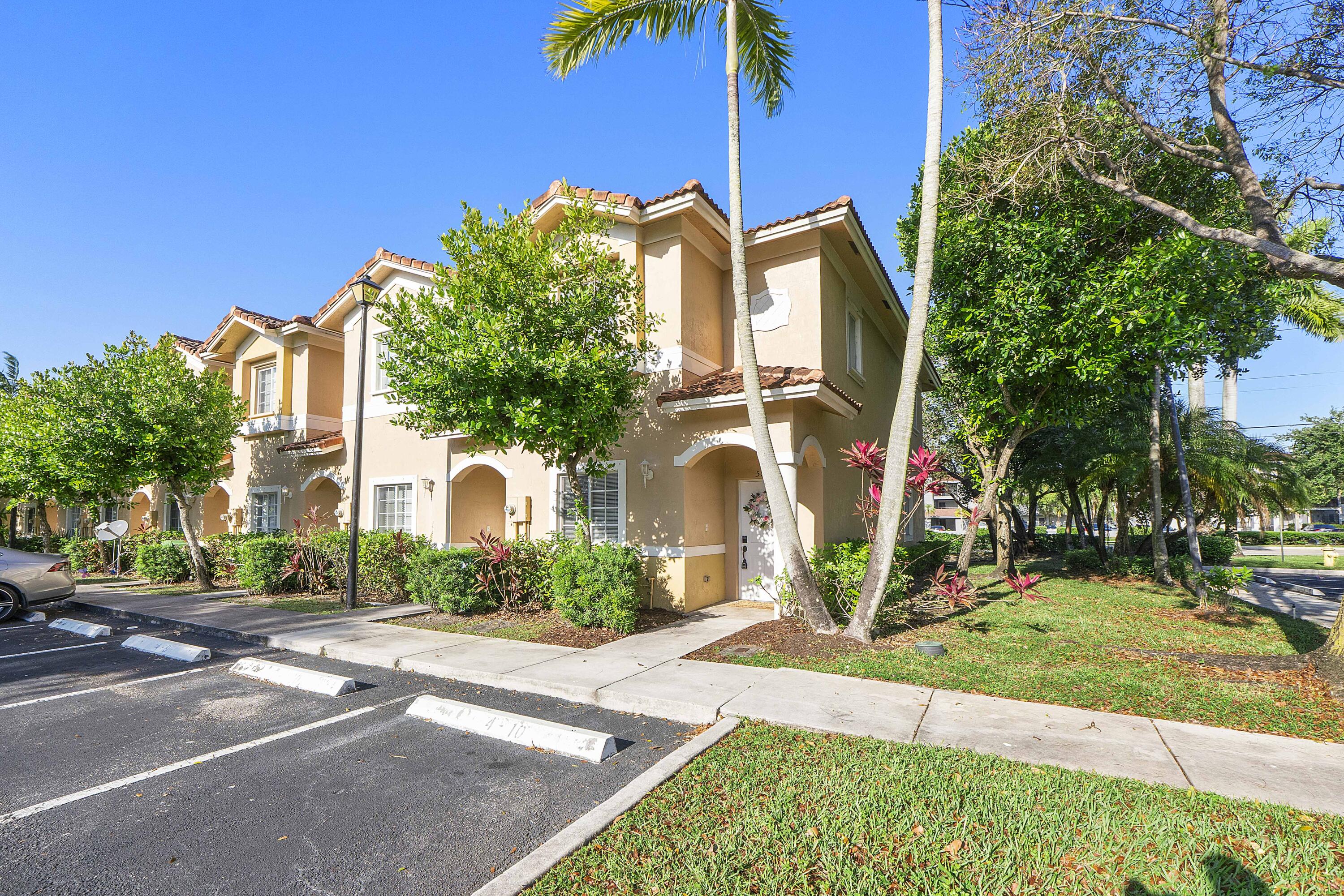 5910 Riverside Avenue Tamarac, FL 33321 - Photo 37 of 47 a front view of a house with garden