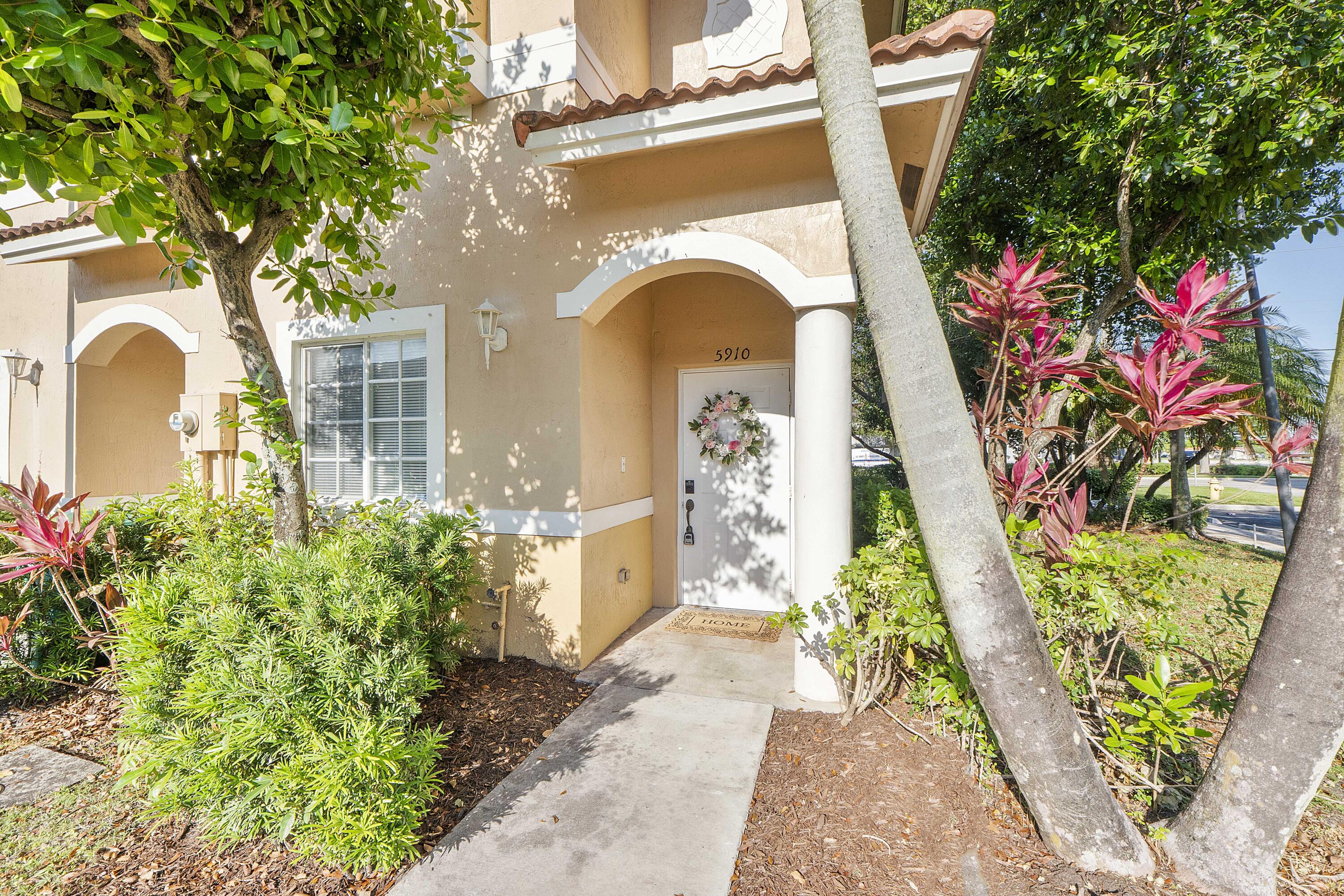 5910 Riverside Avenue Tamarac, FL 33321 - Photo 4 of 47 a front view of a house with garden