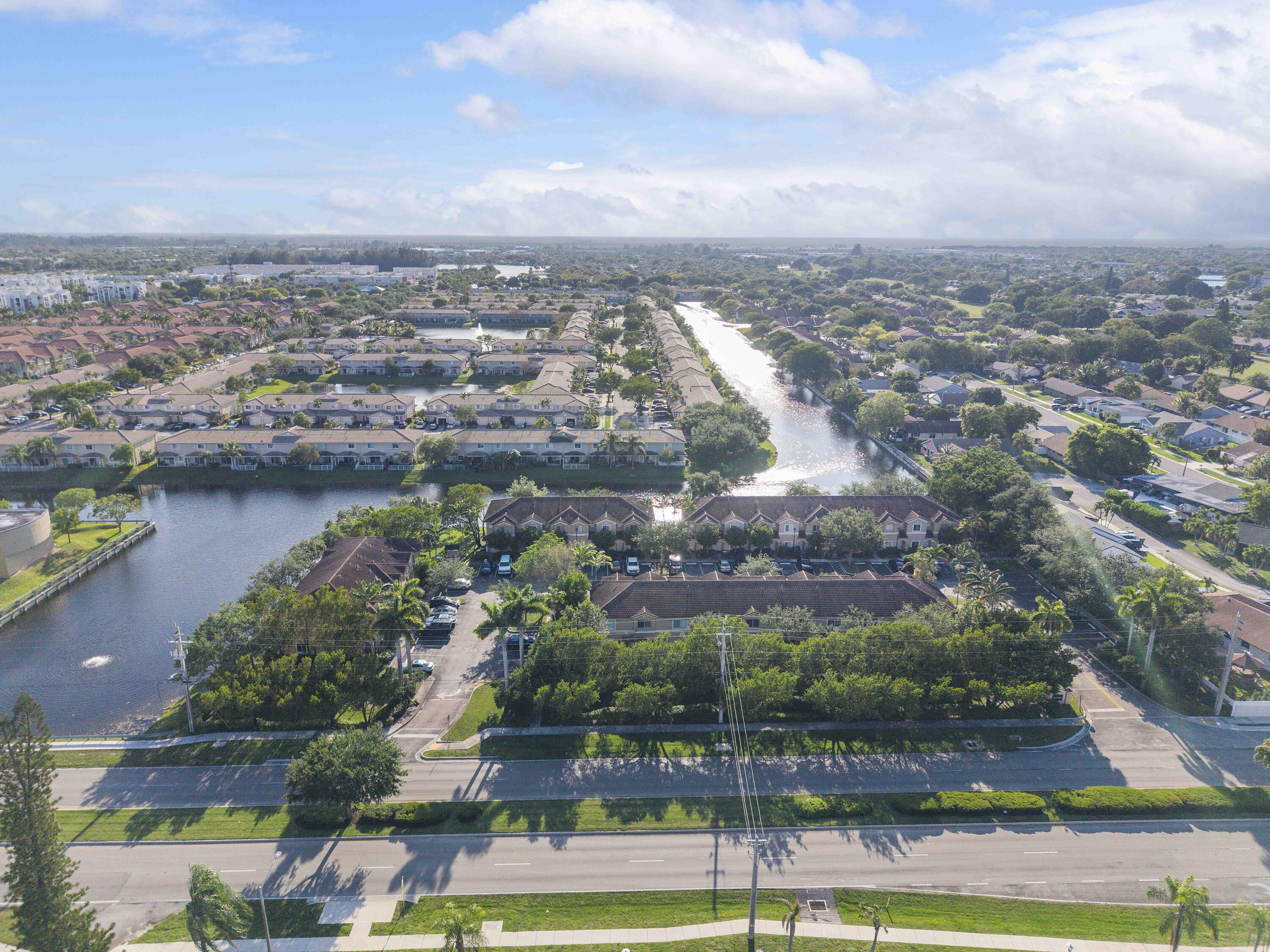 5910 Riverside Avenue Tamarac, FL 33321 - Photo 44 of 47 an aerial view of a city with lots of residential buildings ocean and mountain view in back