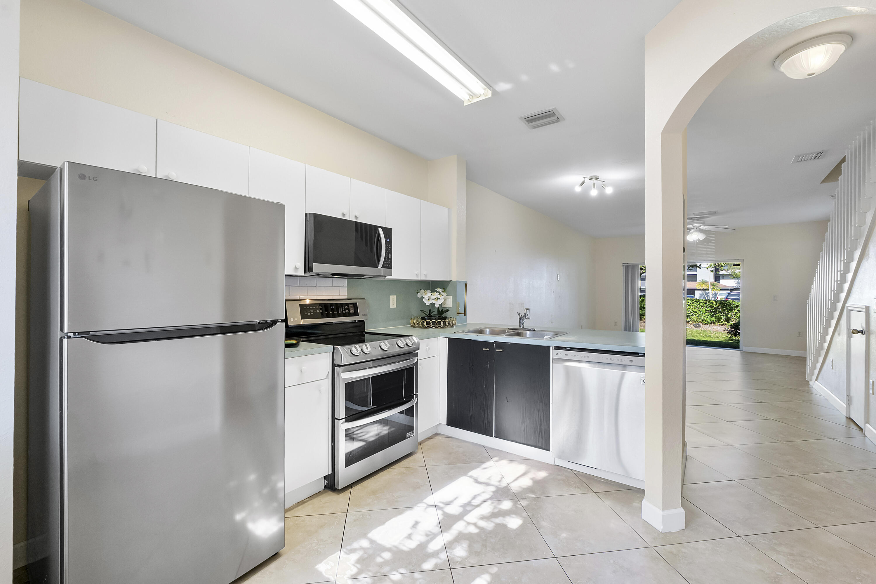 5910 Riverside Avenue Tamarac, FL 33321 - Photo 6 of 47 a kitchen with granite countertop a refrigerator and a stove top oven