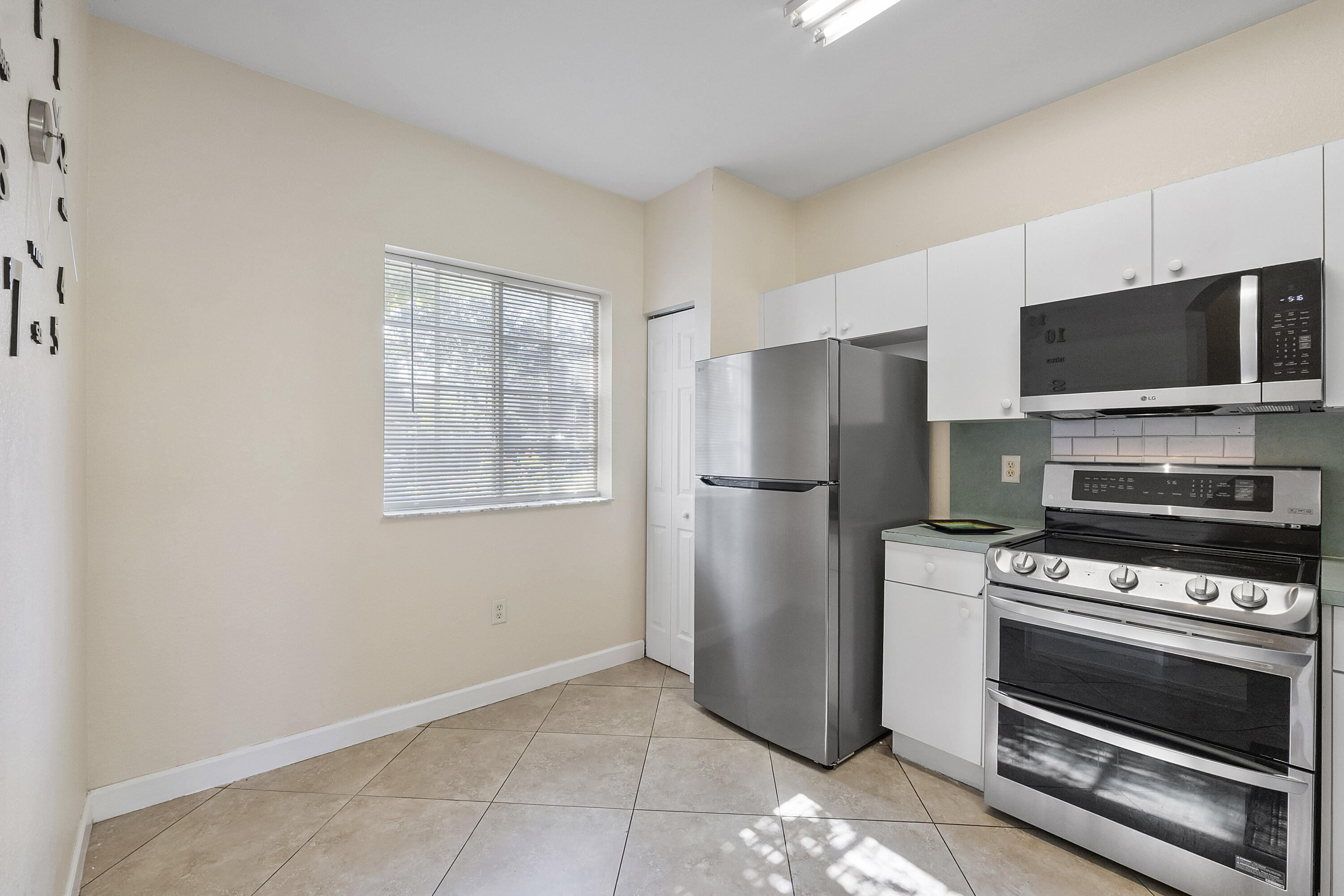 5910 Riverside Avenue Tamarac, FL 33321 - Photo 7 of 47 a kitchen with a refrigerator stove and microwave